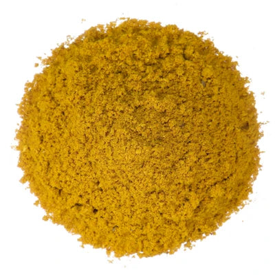 A mound of bright yellow curry powder on a white background.