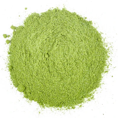 Pile of green matcha powder on a white background.